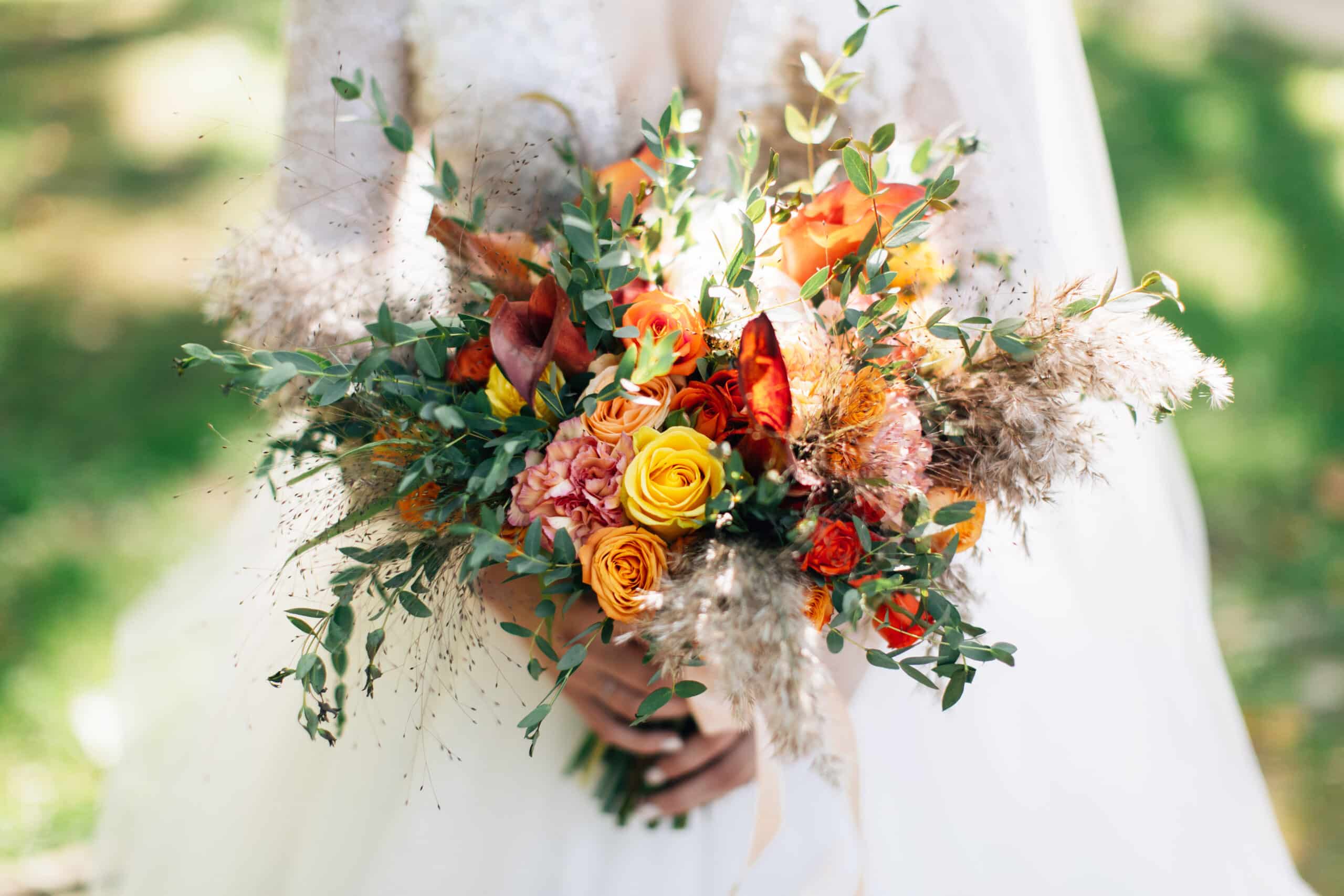 Bride holding big wedding bouquet. Autumnal flowers bouquet